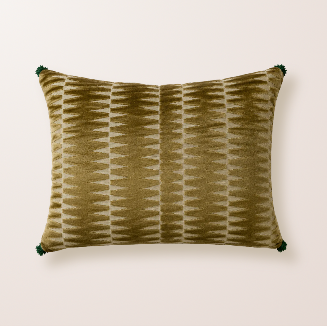 Coussin vert kaki avec des motifs géométriques et des froufrous vert forêt aux extrémités.